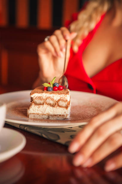 istock woman eating tiramisu 1352861964