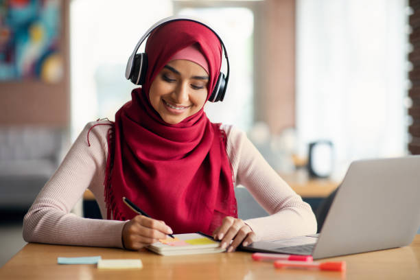 istock Smiling middle-eastern woman having online training, cafe interior 1352866166