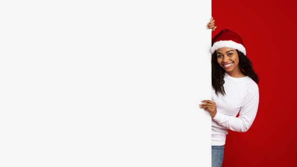 istock Cheerful african american woman standing by empty placard 1352867486