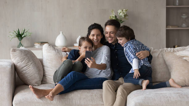 istock Happy friendly family with kids using cellphone. 1352867514