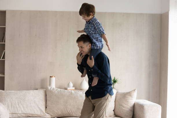 istock Happy young hispanic daddy carrying on shoulders small son. 1352867518