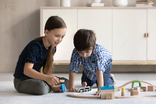 istock Happy small children playing toys at home. 1352867521