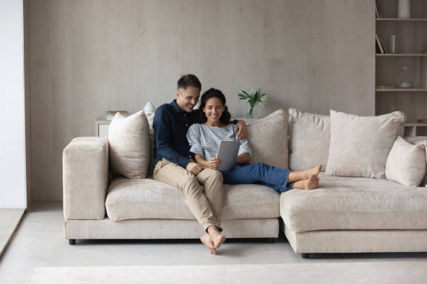 istock Happy loving young family couple using digital tablet. 1352867676