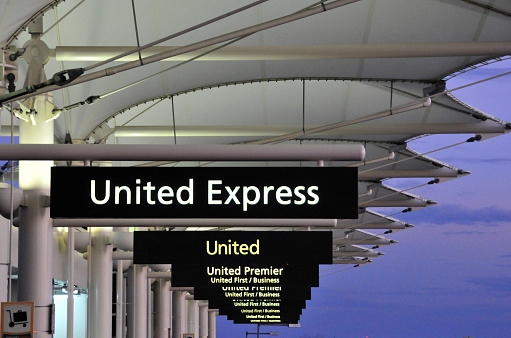 Denver, Colorado, USA: signs at the entrance to the United Airlines (Star Alliance) check-in and kerb side check-in zone - signs at the main terminal, Denver International Airport.
