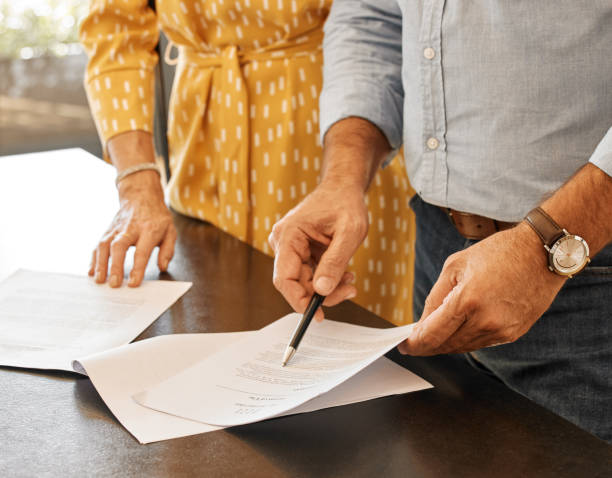 istock Shot of two unrecognizable people going through paperwork 1352869301