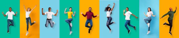 Full length of happy energy international young students jumping from success, victory Full length of happy energy international young students jumping from success, victory, isolated on colorful background, panorama, copy space. Smiling excited people celebrating win, have fun and joy jumping stock pictures, royalty-free photos & images
