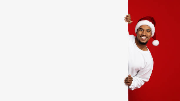 istock Cheerful african american man standing by empty placard, panorama 1352871127