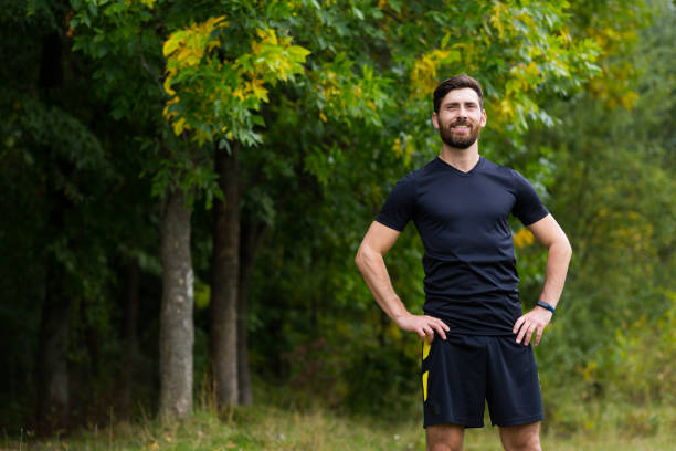 istock Close up portrait young happy bearded man standing in nature between forest trees relaxes, breathes fresh air closing his eyes. Male enjoys a life of peace calm, quiet in the park. Outdoors. Happiness 1352874817
