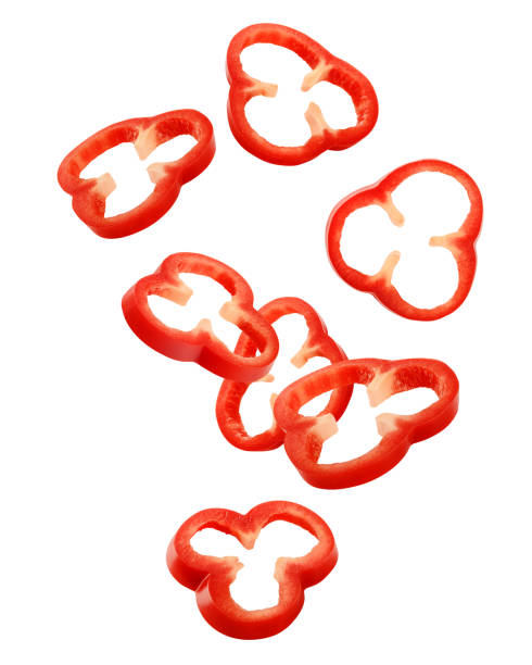 Falling sweet pepper slices, paprika, isolated on white background, clipping path, full depth of field Falling sweet pepper slices, paprika, isolated on white background, clipping path, full depth of field pepper vegetable stock pictures, royalty-free photos & images