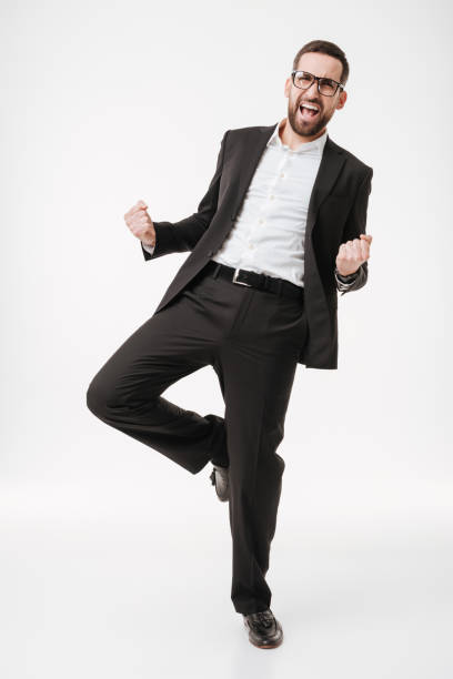 istock Handsome happy young bearded businessman make winner gesture. 1352877198