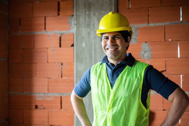 istock Portrait of a confident man with hardhat at construction site 1352877473