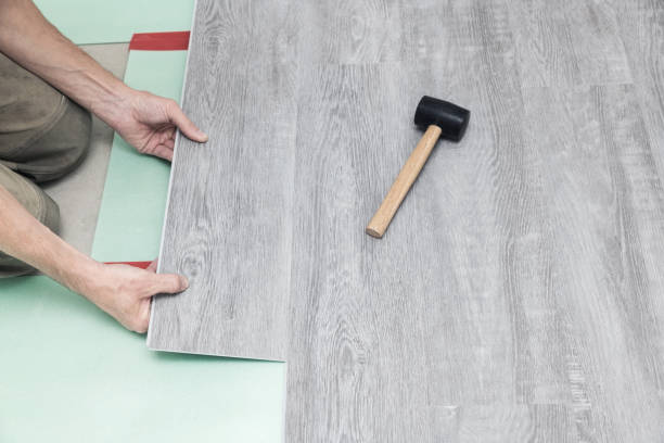 istock Man lays a quartz laminate on the floor 1352878576