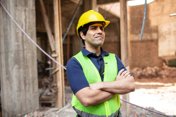 istock Mid-adult construction worker at building site 1352878833