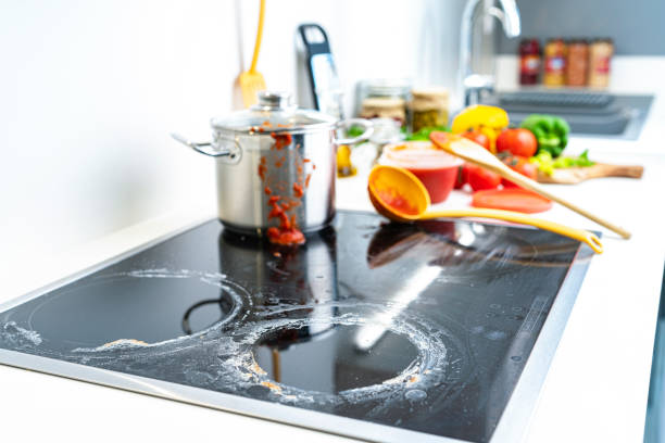 Close up view of a dirty glass stove top before cooking tomato sauce. High resolution 42Mp indoors digital capture taken with SONY A7rII and Zeiss Batis 40mm F2.0 CF lens