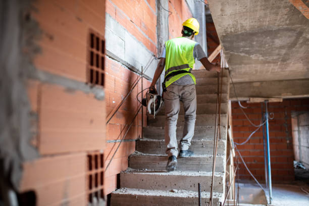 istock Rear view of a construction worker working at building site 1352878886