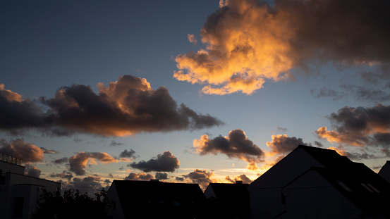 Cloudscape over roof tops at twilight