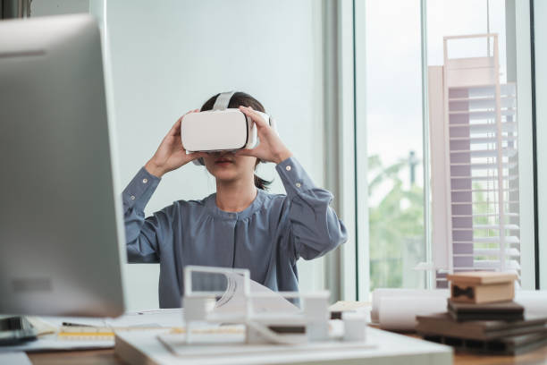 istock Architect wearing virtual reality headset for detail project house model. 1352882351