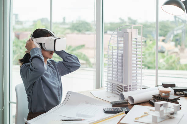 istock Architect wearing virtual reality headset for detail project house model. 1352882363