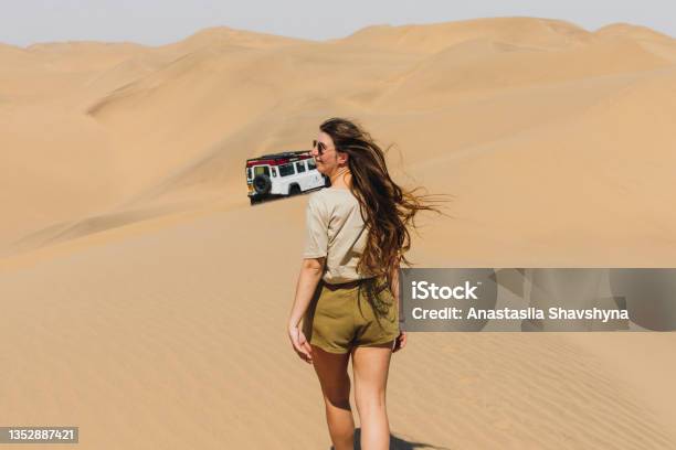 Woman Traveler Enjoying A Day At The Sand Dunes By The Sea With 4x4 Car In Namibia Stock Photo - Download Image Now