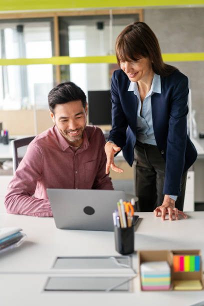 istock Business partners working together on laptop computer in office 1352887746
