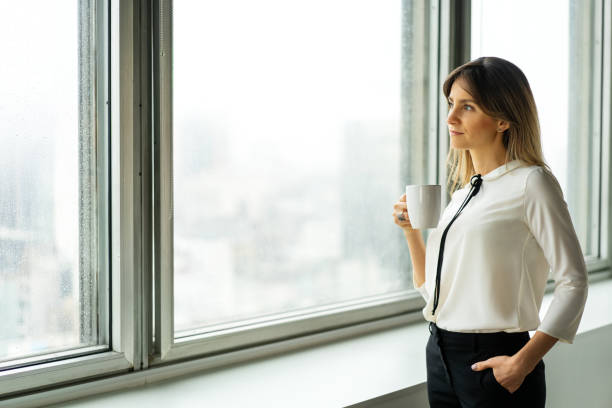 istock Thoughtful woman professional having coffee in the office 1352888034