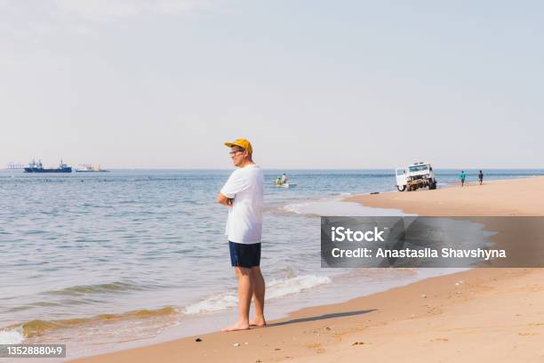 Man Traveler Walking At The Remote Beach Exploring The Beautiful Landscape At Sandwich Harbour Namibia Stock Photo - Download Image Now