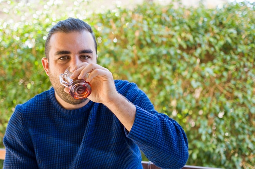 Handsome man drinking Turkish tea