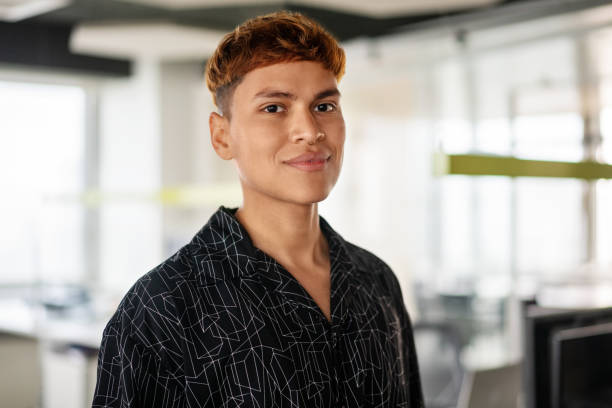 Portrait of a young confident man standing in office