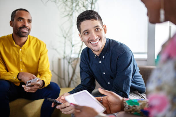 Young man in meeting with colleagues at office lobby