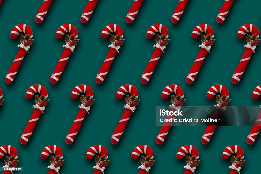 Pattern of red and whit Christmas candy cane on dark green background Pattern of red and whit Christmas candy cane on dark green background. Christmas wallpapers Christmas Card Stock Photo