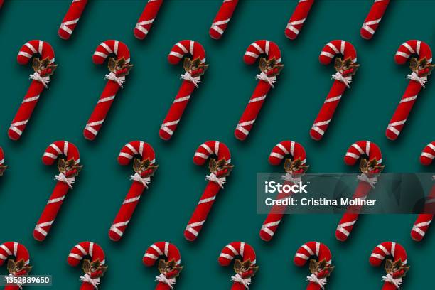 Pattern Of Red And Whit Christmas Candy Cane On Dark Green Background Stock Photo - Download Image Now