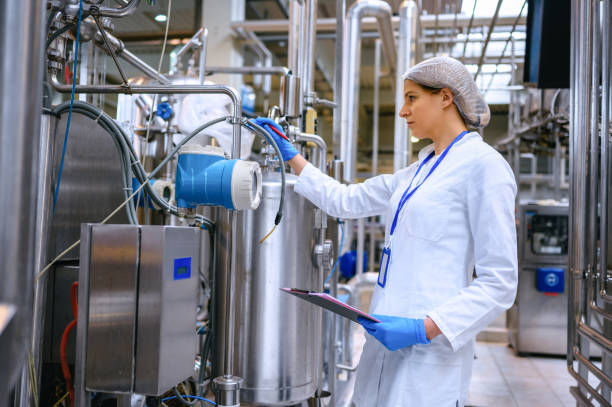 istock Female engineer working on maintenance in bottling plant 1352889681