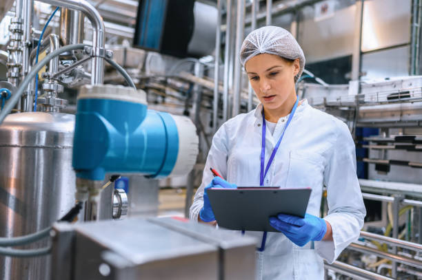 istock Female engineer working on maintenance in bottling plant 1352890589