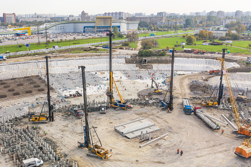 Huge excavation and foundation construction, drilling piles in urban development, aerial view