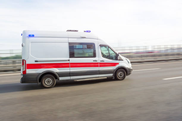 istock Ambulance car rushing down the highway on an emergency call, side view. 1352891298