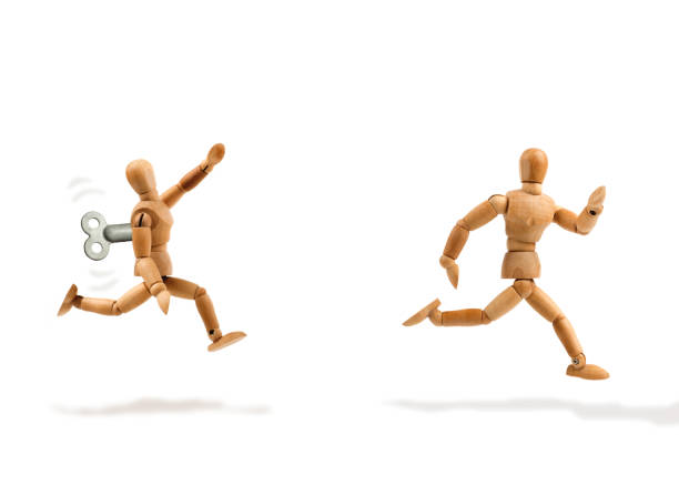 istock Wooden mannequin runs away from a remote controled one 1352891395