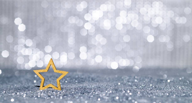 istock Christmas star on shiny silver background 1352891788