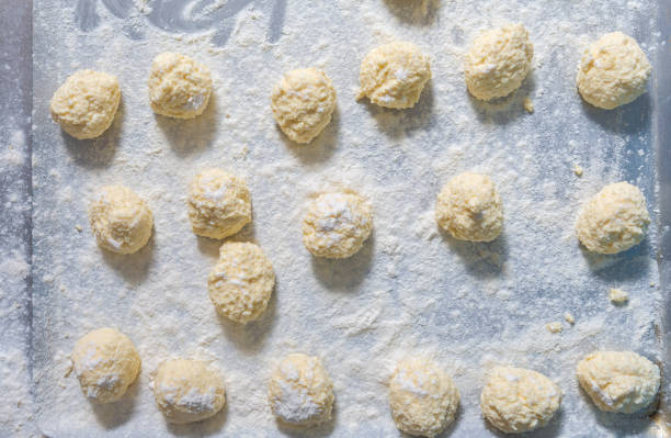istock Cheese cakes being cooked with soft cottage cheese and flour on kitchen table in slavic restaurant 1352892529