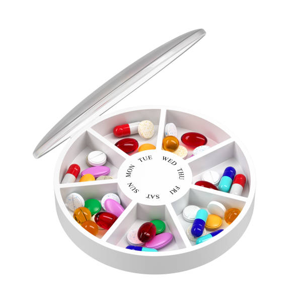istock Round pill box with different tablets and vitamins for a week. Medication organiser. 3d rendering. 1352894511