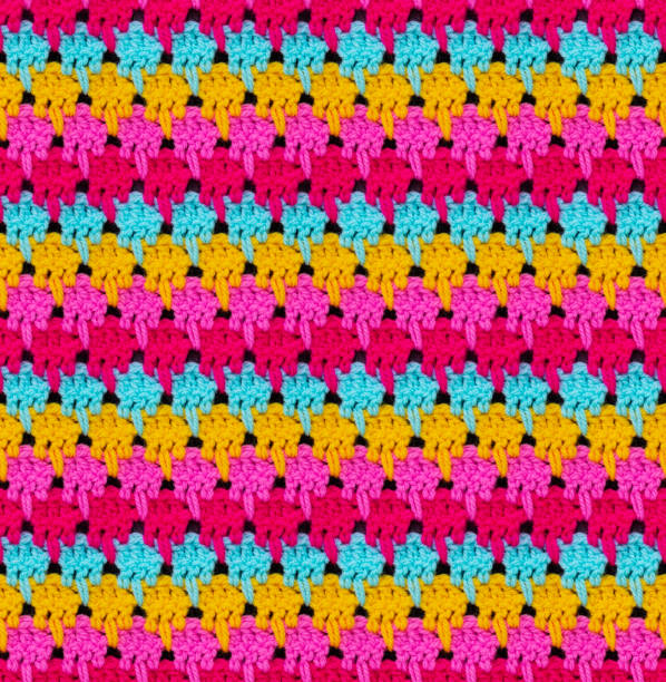 istock Seamless knitted texture. The pattern is crocheted from bright multi-colored acrylic yarn. 1352894529