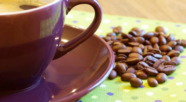 istock Cup of coffee with beans close-up 1352894813