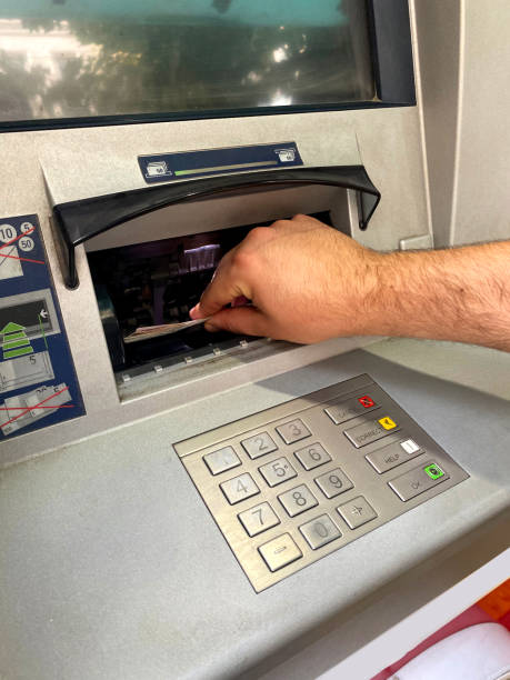 istock The guy who withdraws money from an ATM 1352895639