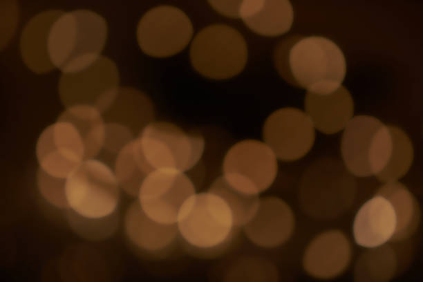 istock Holiday blurred golden bokeh background, glitter, light effect, party. Blurred color light abstract background with bokeh defocused lights 1352895790