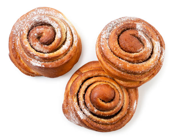 istock Buns with cinnamon on white background, isolated. The view from top 1352897469