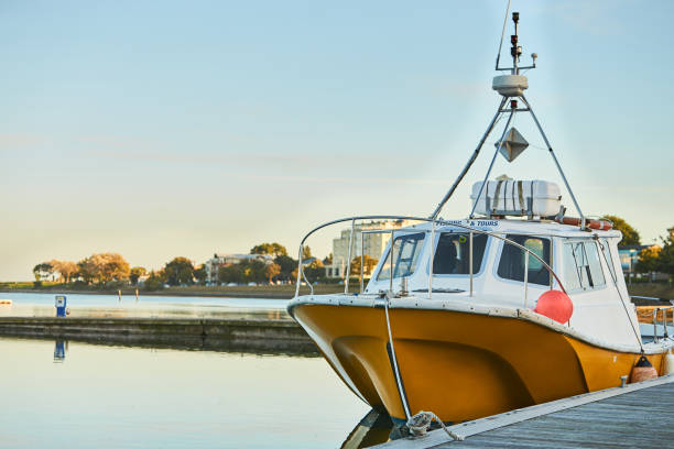 istock Big boat in harbor with cloudy sky in background. 1352899119