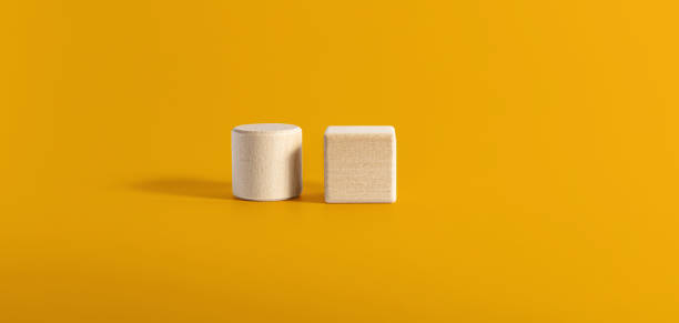 istock Two circular and square wooden blocks are placed side by side on a yellow background. Wood block concept, banner with copy space for text, poster, mockup template. 1352900010