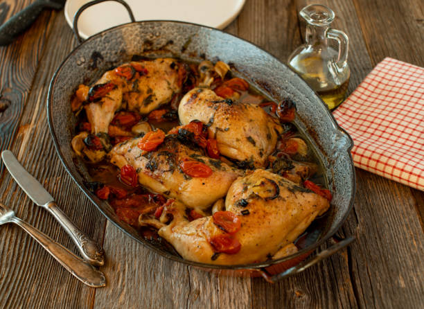 Braised chicken legs with tomatoes, basil, garlic and olive oil stock photo