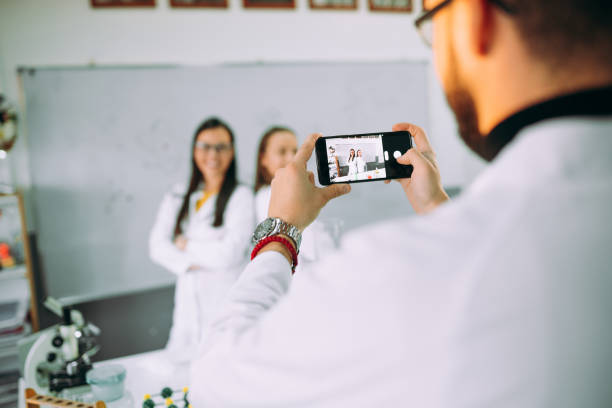 istock Friends in a laboratory classroom using phone 1352901972