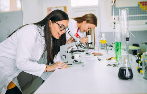 istock A woman looks under a microscope at a laboratory classroom 1352901980