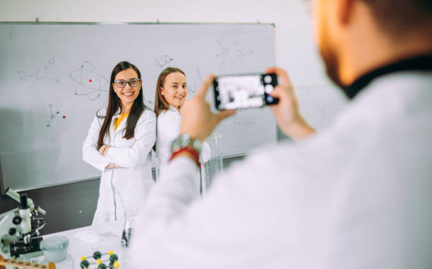 istock Friends in a laboratory classroom using phone 1352902618